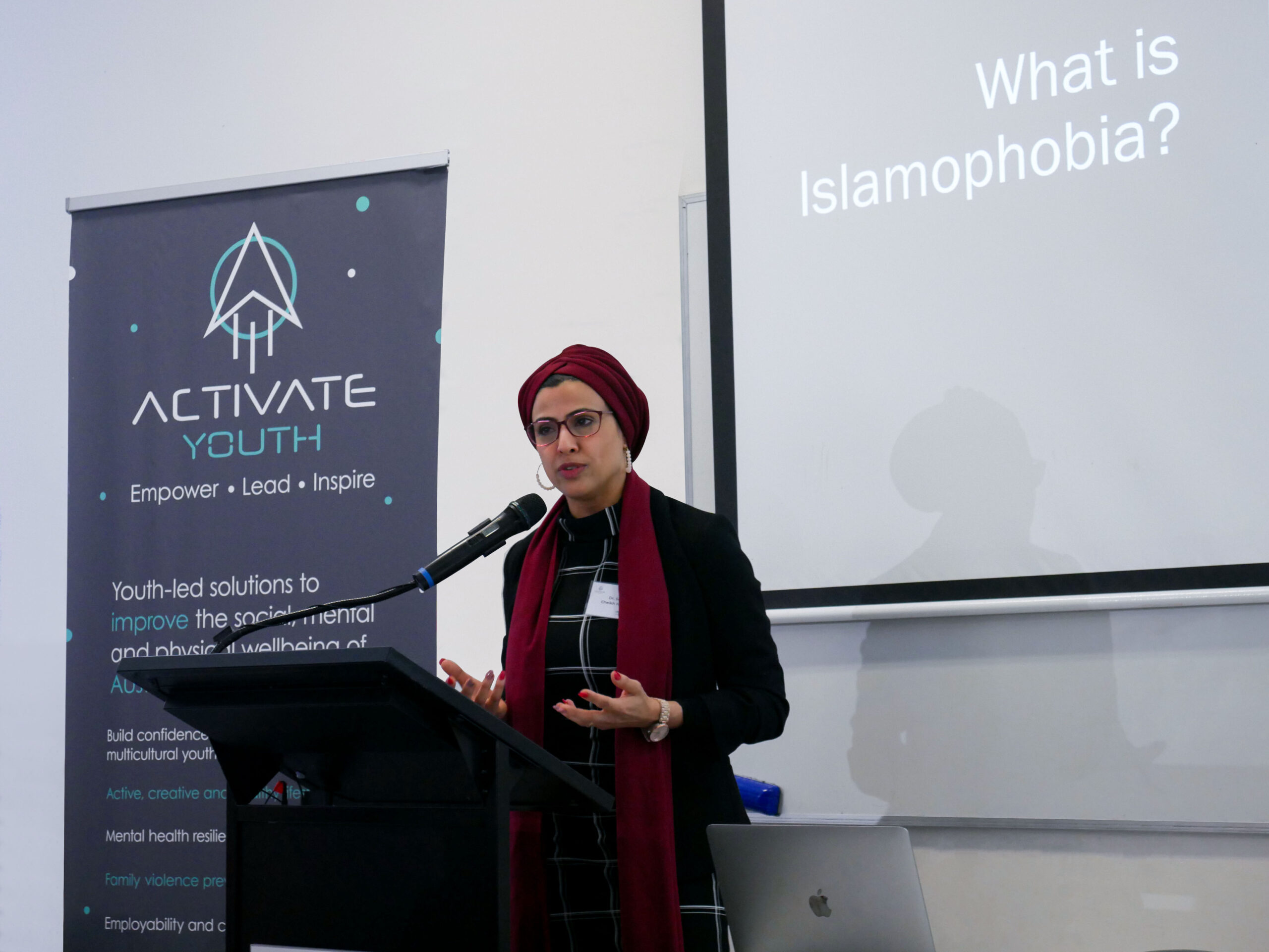 Dr. Sara Cheikh speaking at a conference